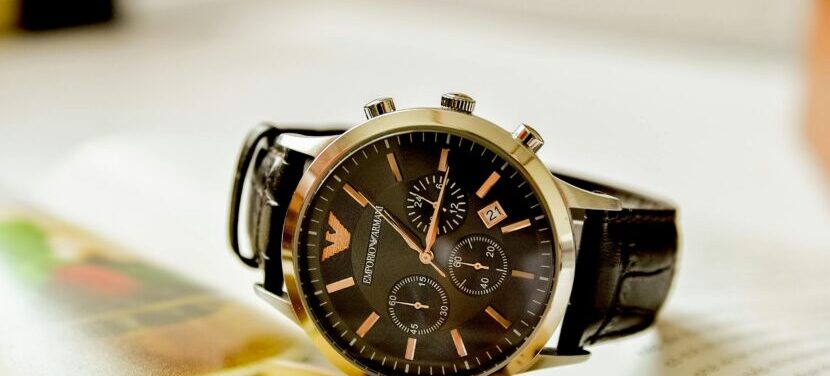 Close-up of a stylish Emporio Armani watch resting on an open book, showcasing luxury and elegance.
