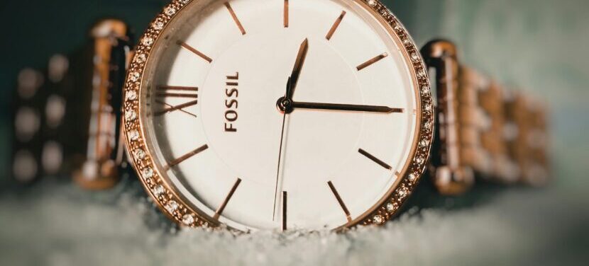 Close-up of an elegant Fossil wristwatch with a gold bezel and sparkling details, captured in Armoor, India.